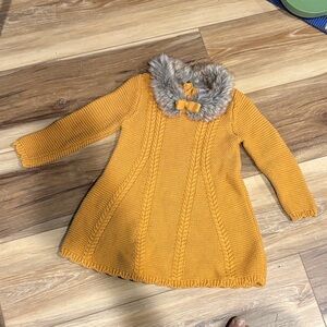 Tan colored sweater dress with fur detail